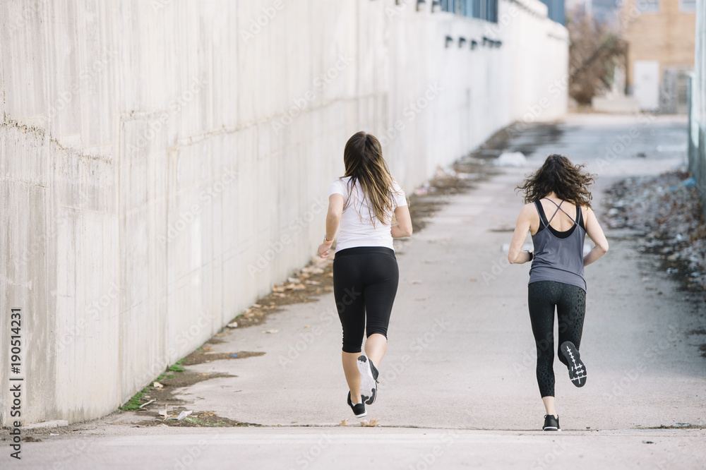 two running woman in the street