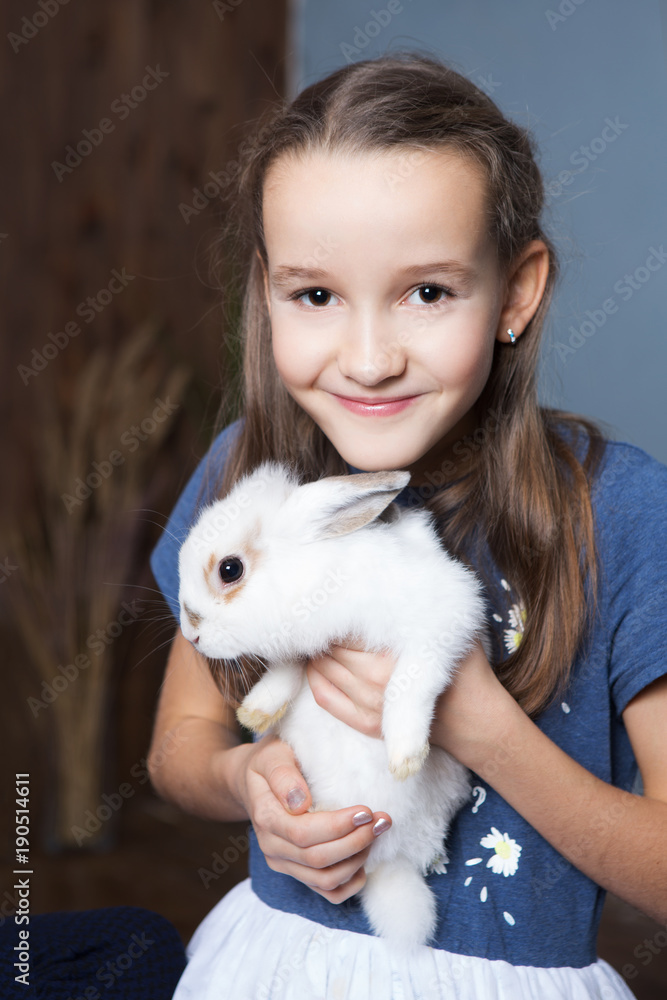 Cute girl is holding a cute little rabbit Cute girl is holding a cute little rabbit