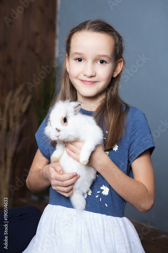 Cute girl  is holding a cute little rabbit
