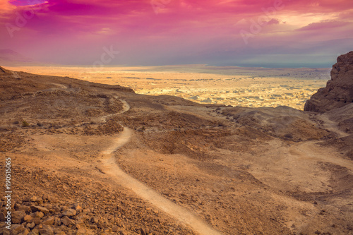 Mountain landscape with beautiful sky. Morning on Masada. Dirt road in mountain. Israel