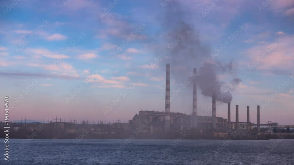 smoke from the pipes of power plant station at the bank of a river
smoke from the pipes of power plant station at the bank of a river
