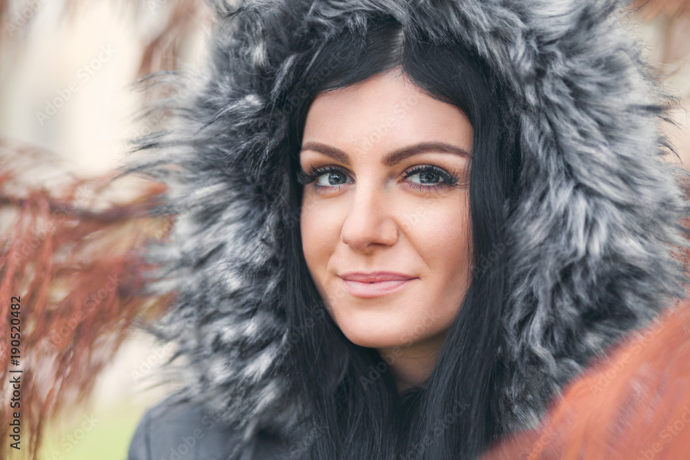 Beautiful woman wearing a fur hood winter coat Beautiful woman wearing a fur hood winter coat