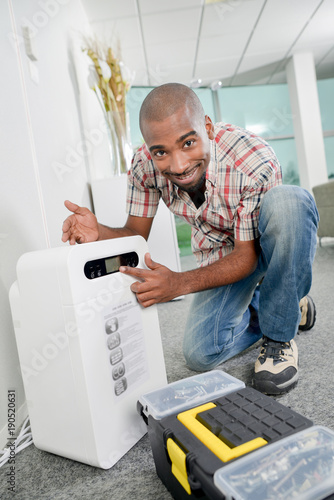 Man installing a dehumidifier photo