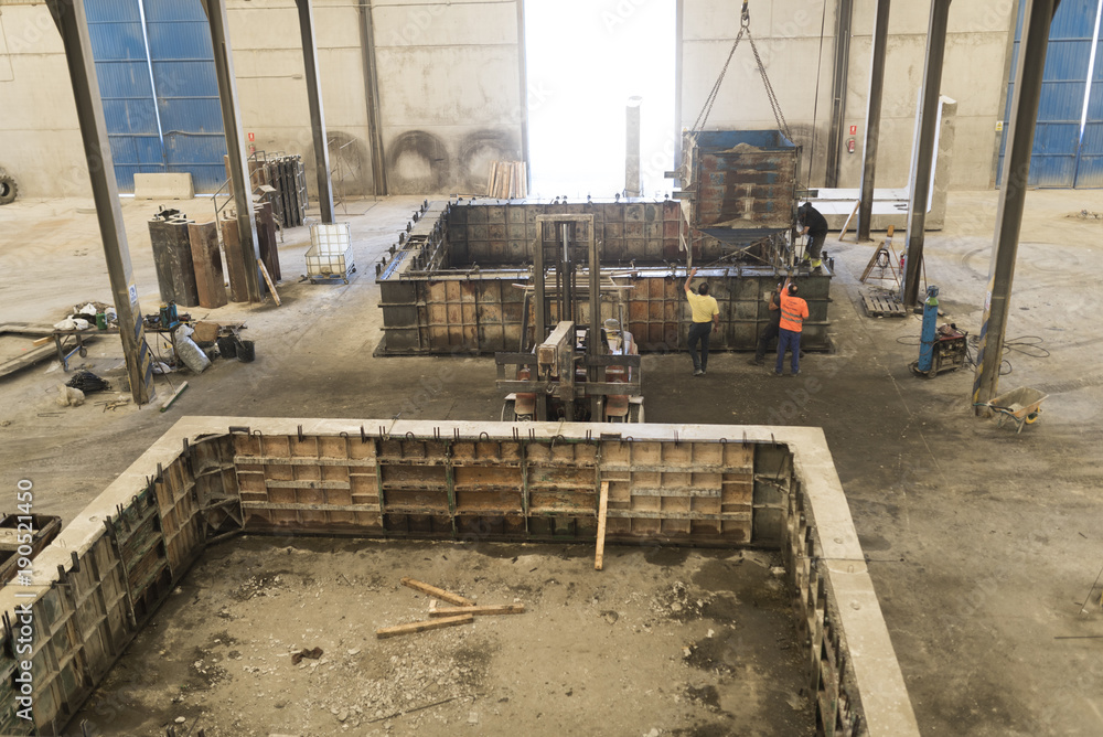 Mixer with cement in crane ready for fill the mold for create cement structures Mixer with cement in crane ready for fill the mold for create cement structures
