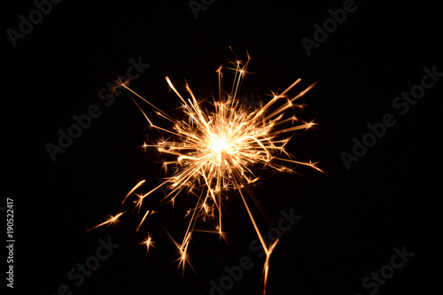 Blank background with bengal fire .Sparkler . New year party sparkler on black background A man holds a burning Bengal flame in his hands