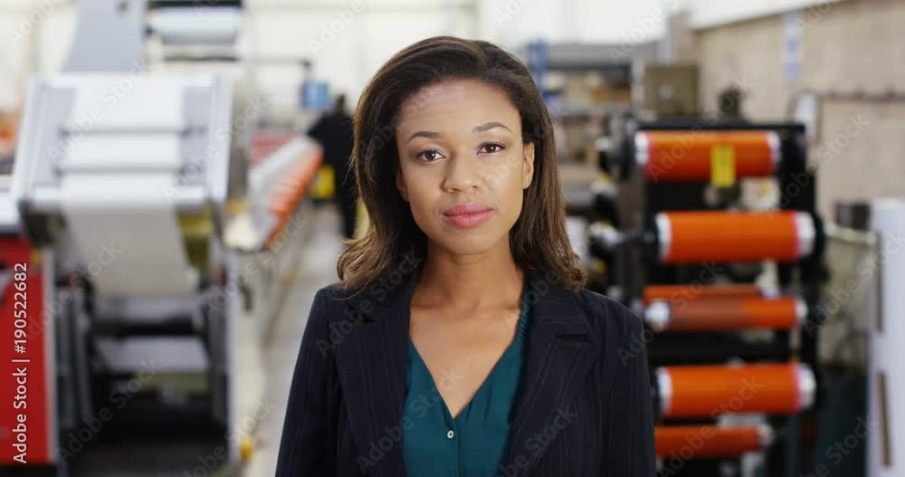 4k, Young female engineer nodding at the camera while having a video conference in the factory. 4k, Young female engineer nodding at the camera while having a video conference in the factory.