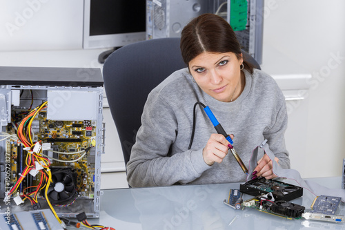 Portrait of woman using soldering iron