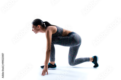 Individual kind of sport. Side profile view photo of concentrated powerful strong focused beautiful woman standing at start line, she is ready to run the distance, isolated on white background