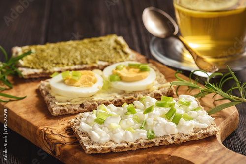 Rye crisp bread sandwiches with eggs, pesto and cottage cheese.