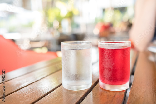 sweet drinking water in clear glass, red water, on the table