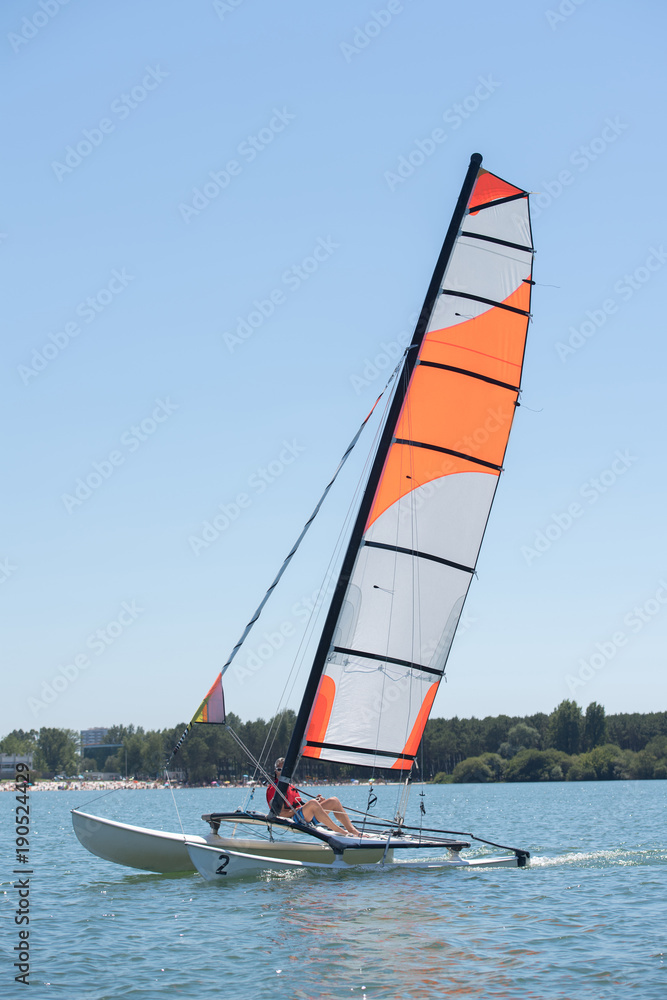 Naklejka premium sailing on a lake - summer and sports theme