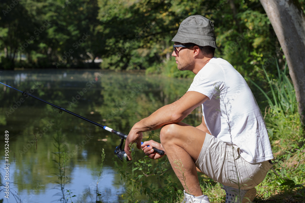 man with a fishing rod at the lake man with a fishing rod at the lake