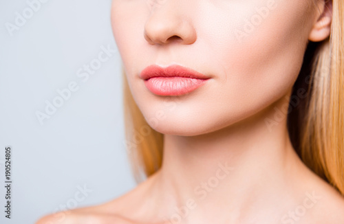 Close up cropped photo of big natural woman's lips without lipstick and perfect skin.