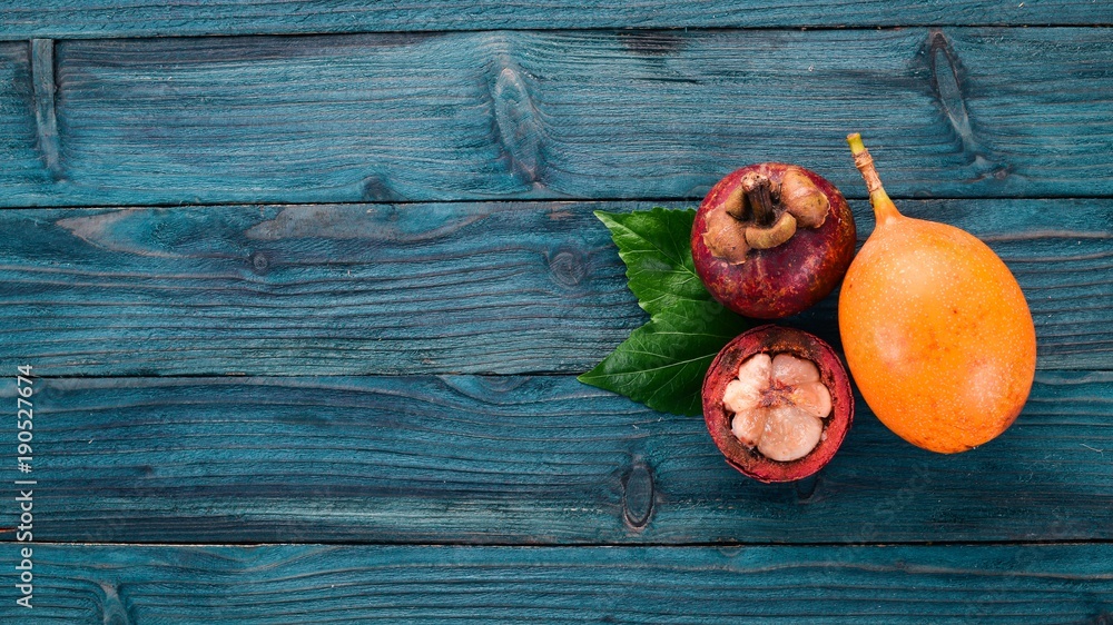 Granadilla Tropical Exotic Fruits. On a wooden background. Top view. Copy space. Granadilla Tropical Exotic Fruits. On a wooden background. Top view. Copy space.