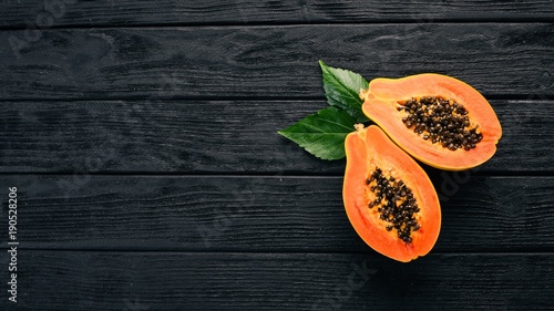 Papaya. Tropical Fruits. On a wooden background. Top view. Copy space. photo