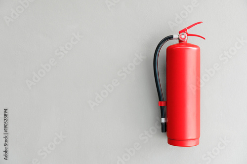 Fire extinguisher on the gray wall