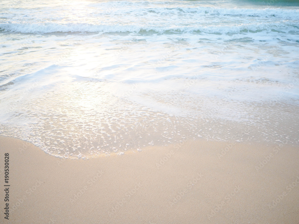 Soft wave of the tropical sea on the sandy beach.