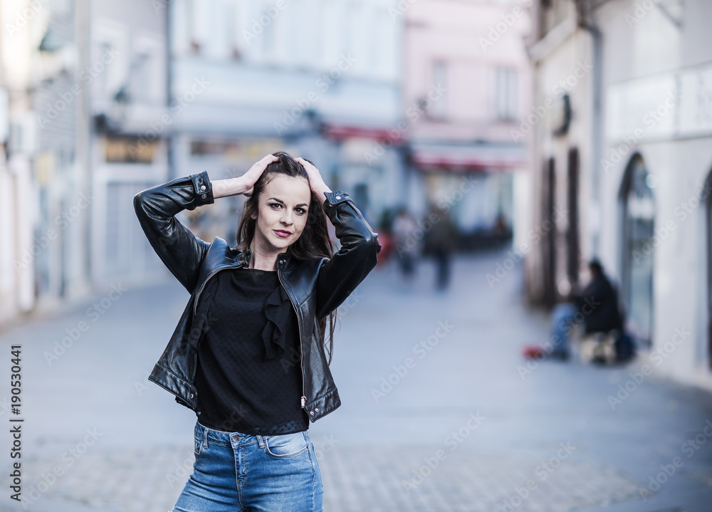beautiful young girl with long hair standing on the street of the city beautiful young girl with long hair standing on the street of the city