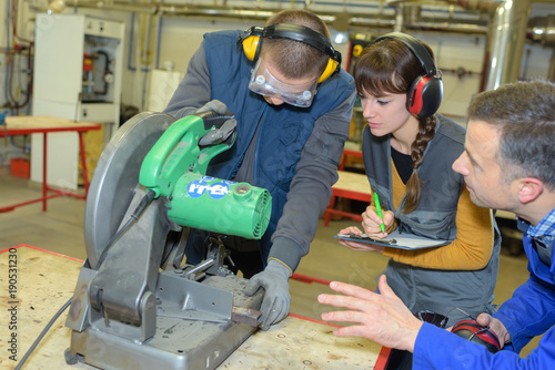 student in ironworks class using circular saw