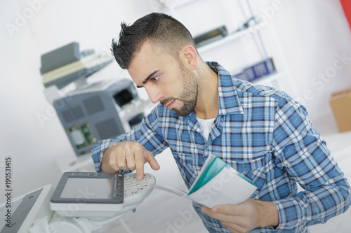 businessman learning to use office printer