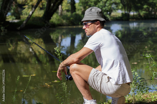 man with fishing rod at a lake