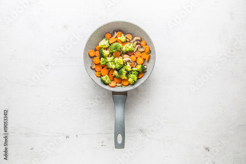 Vegan ceramic pan broccoli carrot and mushrooms. Vegan food and ingrediention.