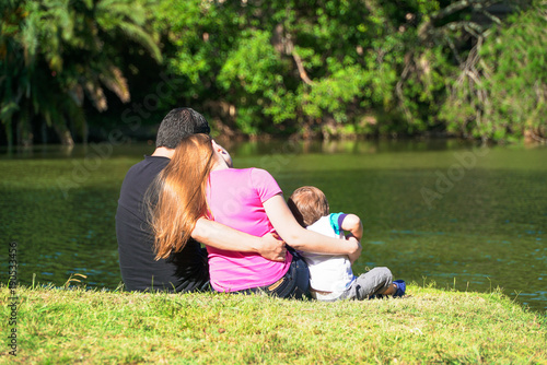 family sitting by the lake © Andriy Petrenko