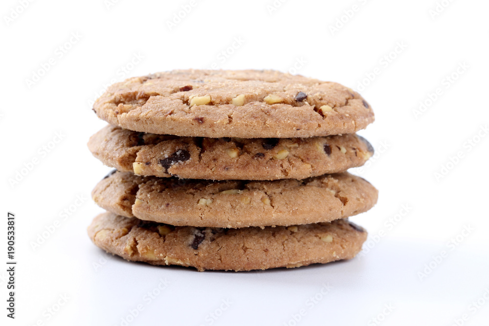 Chocolate chips and hazelnuts over white background Chocolate chips and hazelnuts over white background