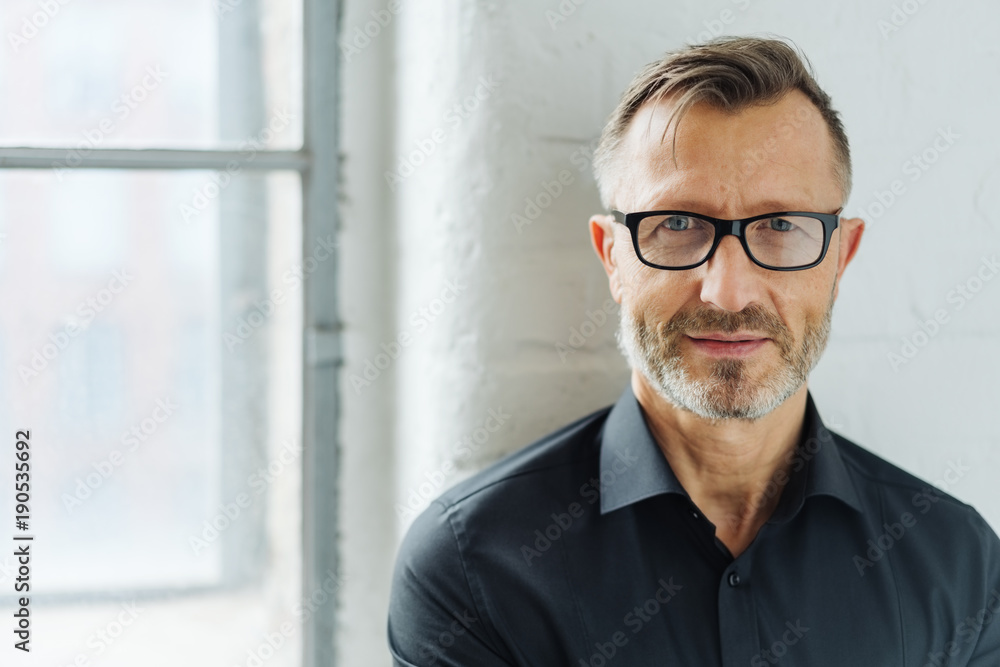 Bearded man wearing glasses looking at camera Bearded man wearing glasses looking at camera