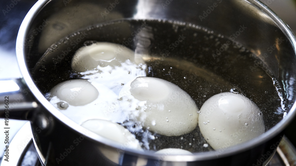 eggs boiling in pan of water eggs boiling in pan of water