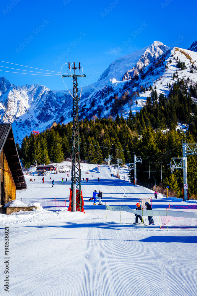 Fototapeta premium Familiy winter sport in Bellevue Les Houches Saint-Gervais, France. Top of Alps mountain near Mont Blanc. Perfect snow depths for winter sport, ski. Famous touristic area with beautiful landscape. 