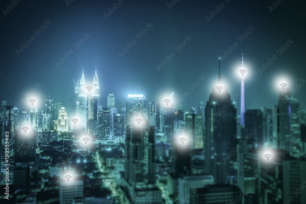 Obraz premium Cityscape of Kuala lumpur city skyline with wireless connecting at night in Malaysia. Vintage tone