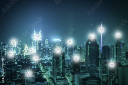 Cityscape of Kuala lumpur city skyline with wireless connecting at night in Malaysia. Vintage tone