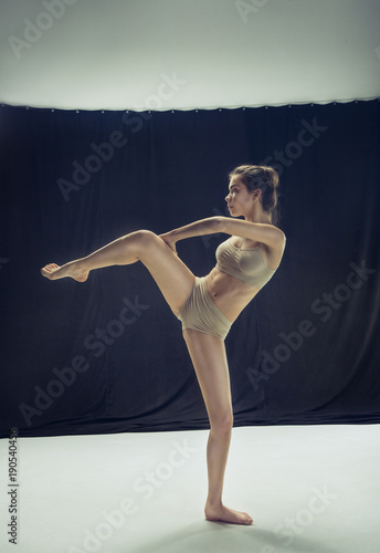 Young teen dancer ion white floor background. photo