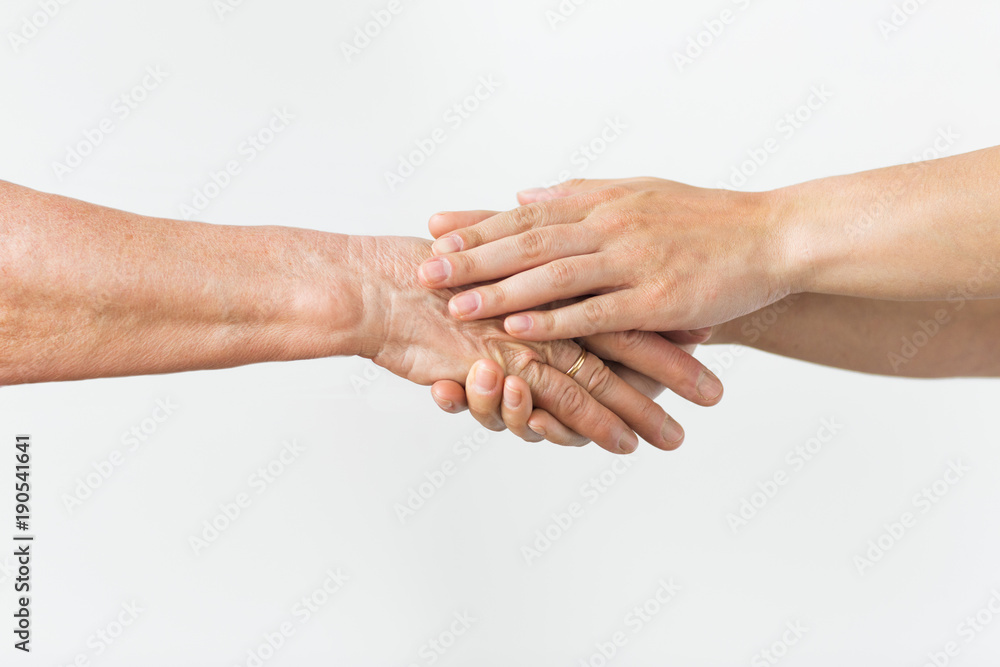 Fototapeta premium close up of senior and young woman holding hands