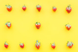 Fresh ripe strawberry. Pattern on yellow pastel background top view copy space