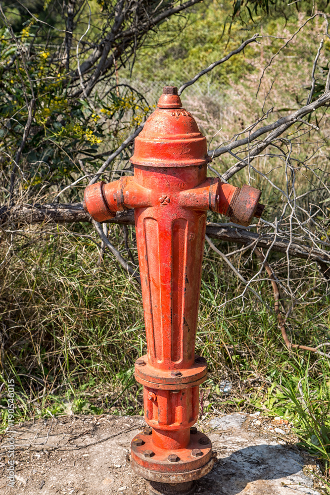 Red fire hydrant in the countryside Red fire hydrant in the countryside