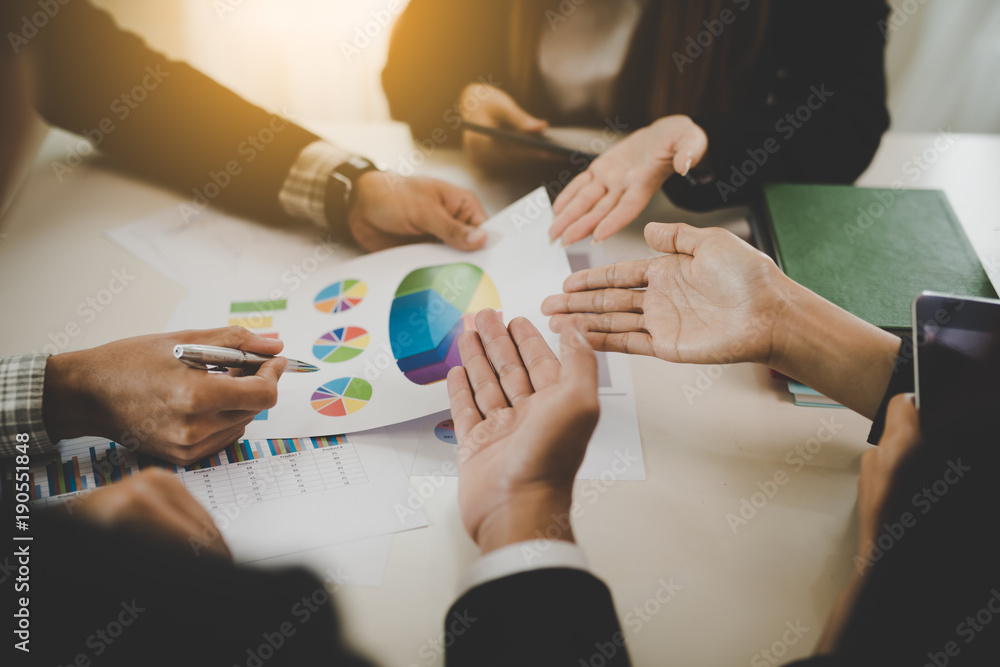 A group of business men and women are meeting together to see graphs about business marketing sales target. teamwork business meeting concept.