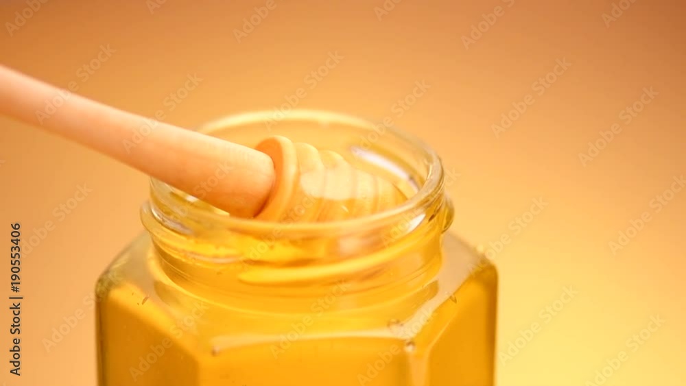 Honey. Healthy organic thick honey dipping from the wooden spoon. Slow motion 4K UHD video footage. 3840X2160 Honey. Healthy organic thick honey dipping from the wooden spoon. Slow motion 4K UHD video footage. 3840X2160