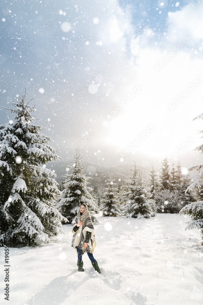 Happy young woman walking in winter time. Happy girl having fun in the snow. Snow covered trees in the winter sun light. Snowy pine trees on a winter landscape. snovy trees on winter mountains