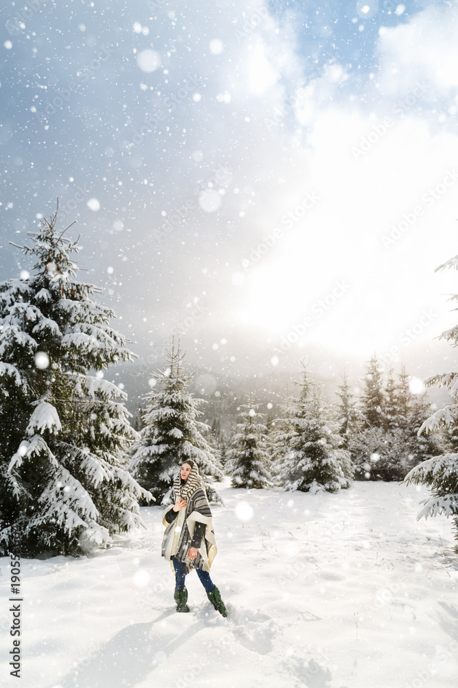 Happy young woman walking in winter time. Happy girl having fun in the snow. Snow covered trees in the winter sun light. Snowy pine trees on a winter landscape. snovy trees on winter mountains Happy young woman walking in winter time. Happy girl having fun in the snow. Snow covered trees in the winter sun light. Snowy pine trees on a winter landscape. snovy trees on winter mountains