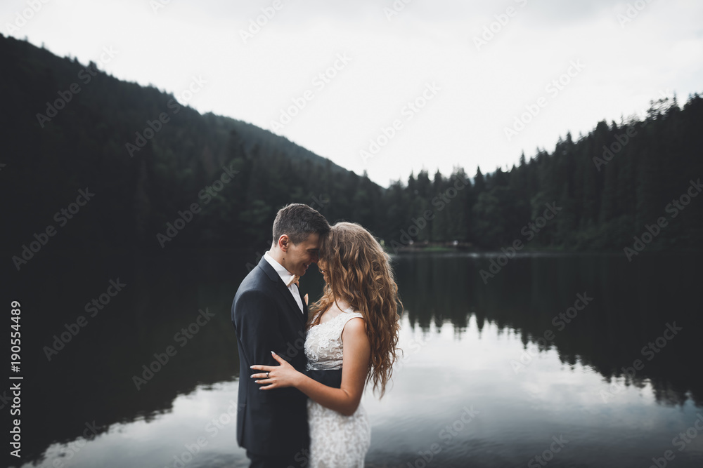 Beautiful gorgeous bride posing to groom and having fun, luxury ceremony at mountains with amazing view, space for text, wedding couple