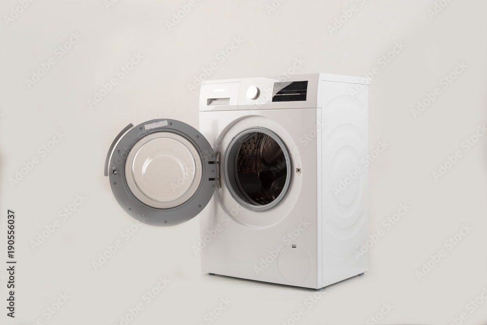 Parents bought a new washing machine. The children try to turn it on and wash the soft toys. Happy boys are playing at home. Parents bought a new washing machine. The children try to turn it on and wash the soft toys. Happy boys are playing at home.