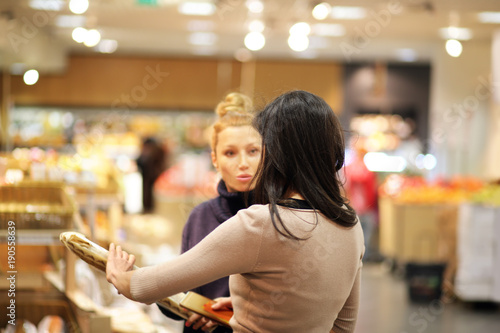 Women choosing bread from a supermarket,selective focus