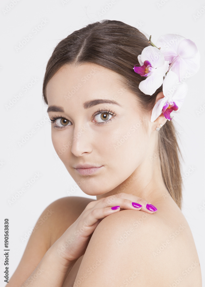 Portrait of a beautiful woman with flowers in her hair on an isolated white background Portrait of a beautiful woman with flowers in her hair on an isolated white background