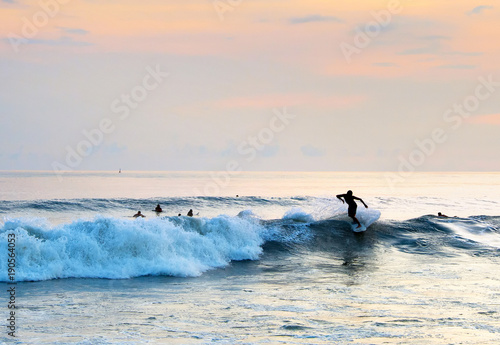 Surfer riding a wave. Bali