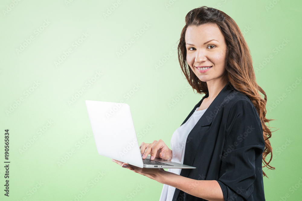Portrait of young beautiful brunnete woman holding laptop Portrait of young beautiful brunnete woman holding laptop
