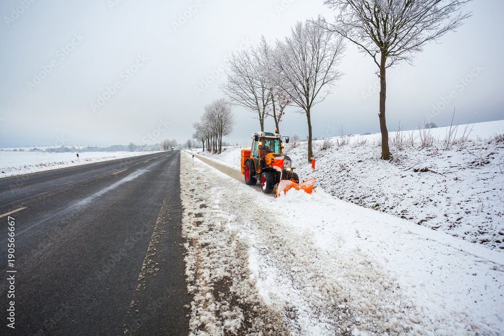 tractor cleans the bicycle road from snow, winter landscape tractor cleans the bicycle road from snow, winter landscape