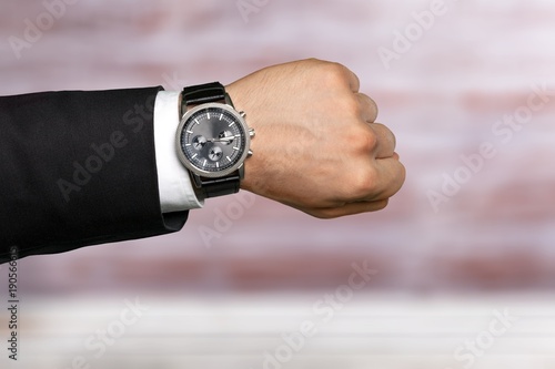 Businessman pointing at hand watch
