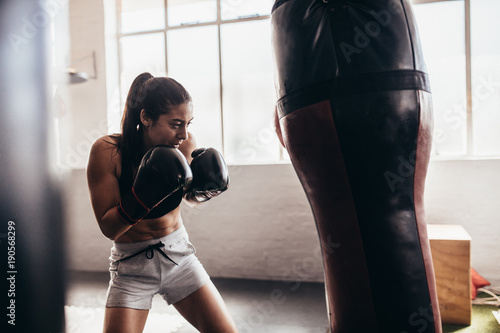 Female boxer training inside a boxing ring © Jacob Lund